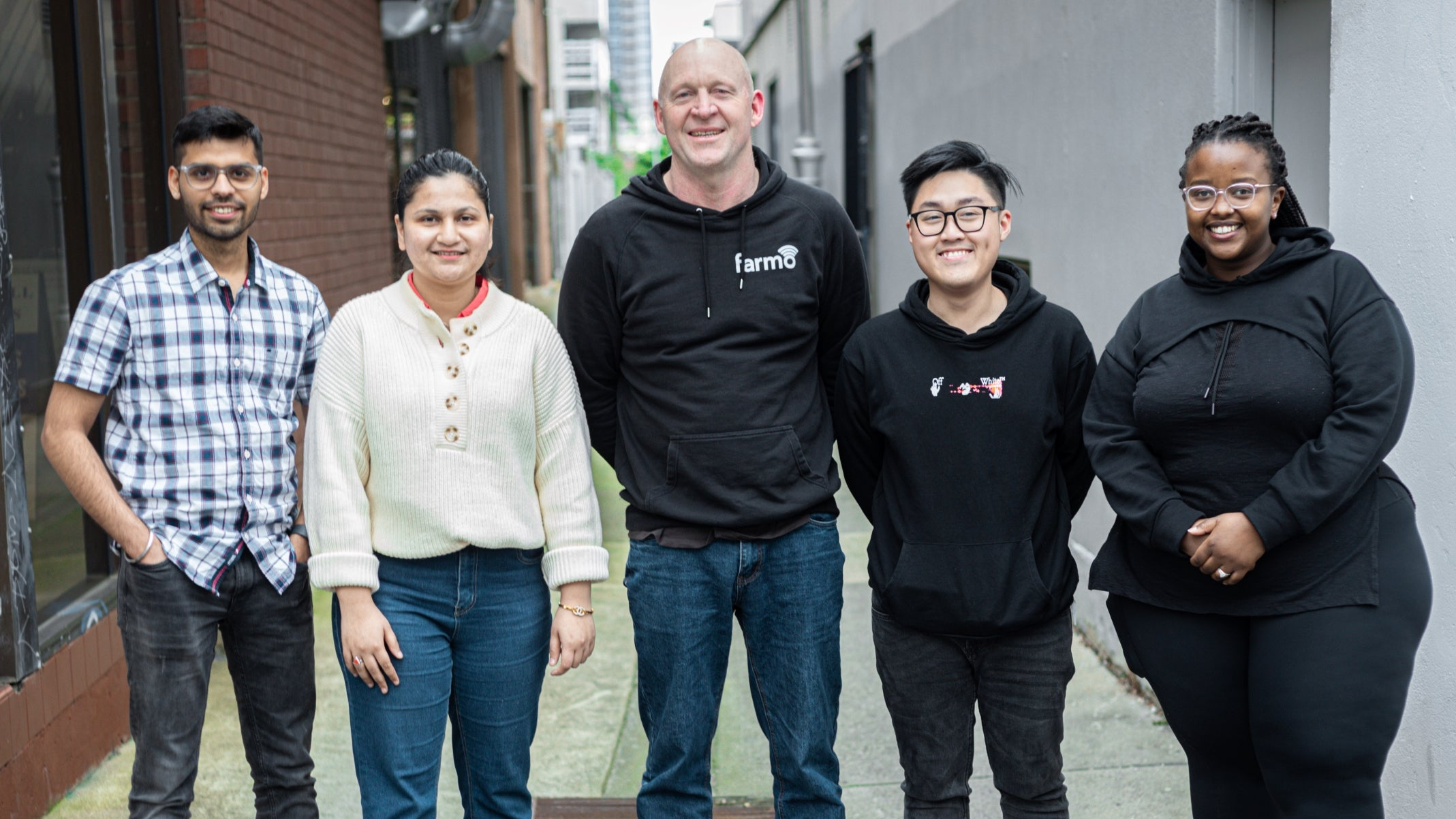 Five Farmo Staff Members Standing together smiling. Team Photo