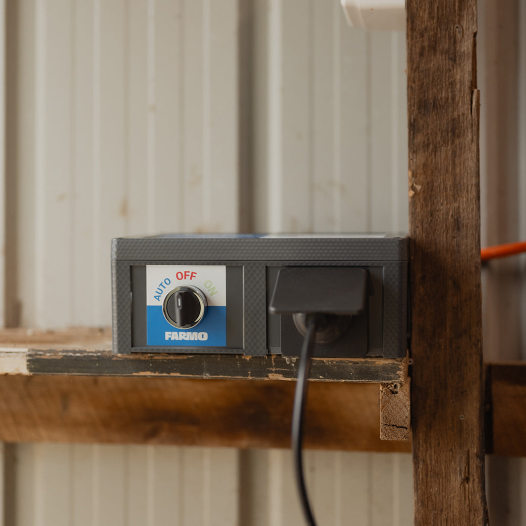 Farmo Smart Plug Control panel with a switch labeled 'Auto' 'Off' and 'On'on a wooden surface.