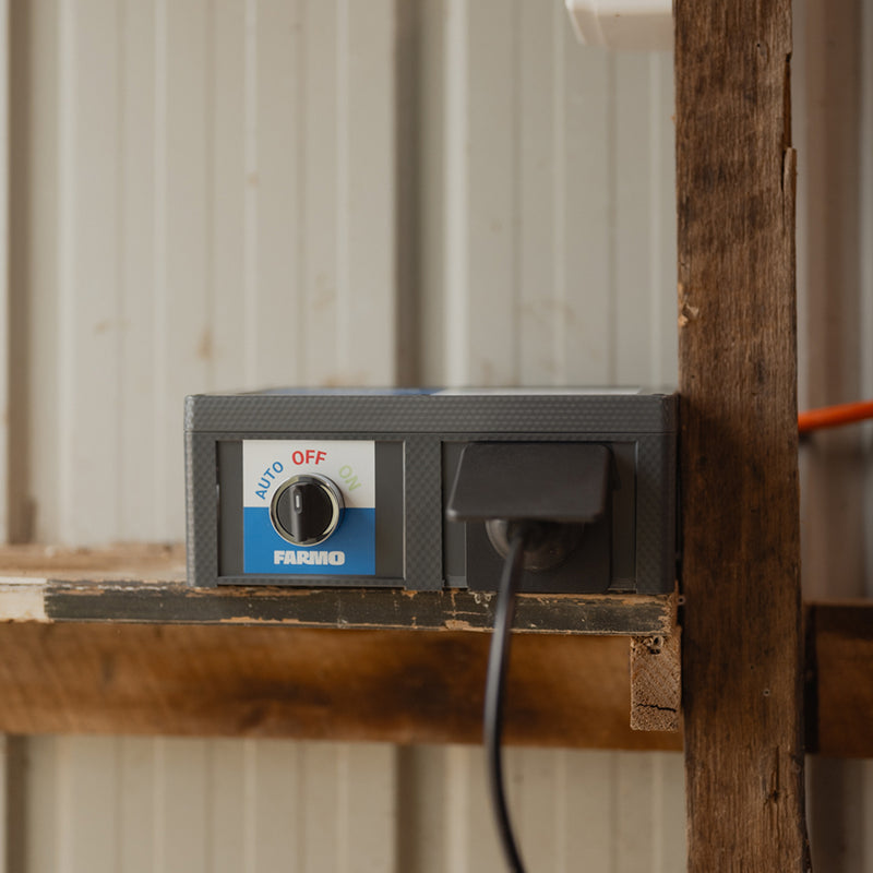 Farmo Smart Plug Control panel with a switch labeled 'Auto' 'Off' and 'On'on a wooden surface.