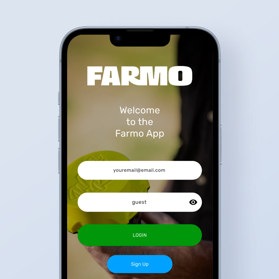 Phone displaying the Farmo app login screen with a blurred background